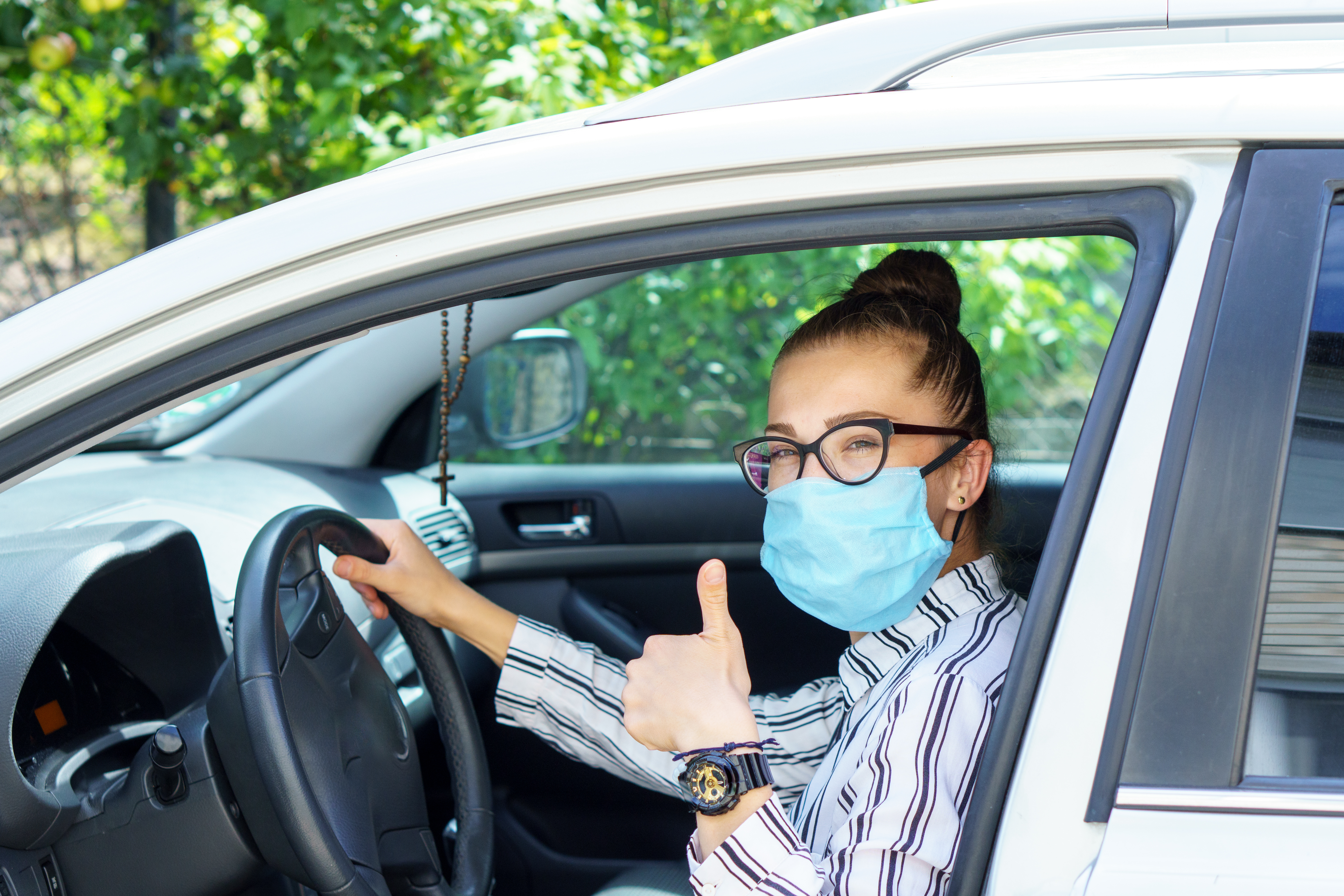 an expert NEMT driver with mask on in a wheelchair-accessible van